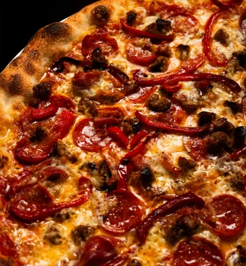 Pepperoni, sausage, and roasted red pepper pizza toppings at Sacred Slice Pizza Barcelona